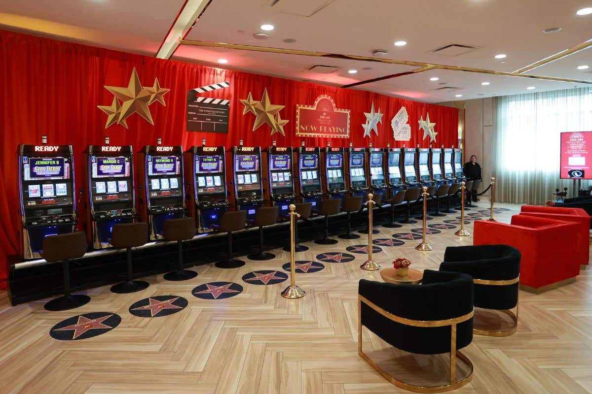 Slot tournament setup with themed décor and rows of machines.