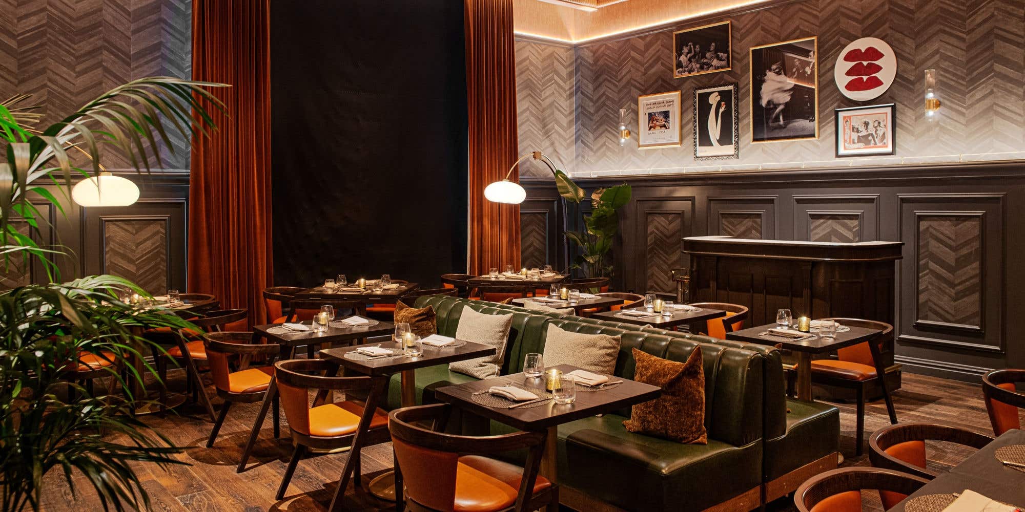 Elegant restaurant interior with dark wood paneling, plush booth seating, and warm lighting.