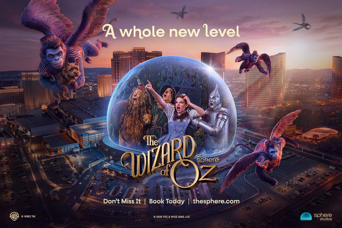 The Wizard of Oz at Sphere poster showing the main characters in a bubble over a city with flying monkeys.