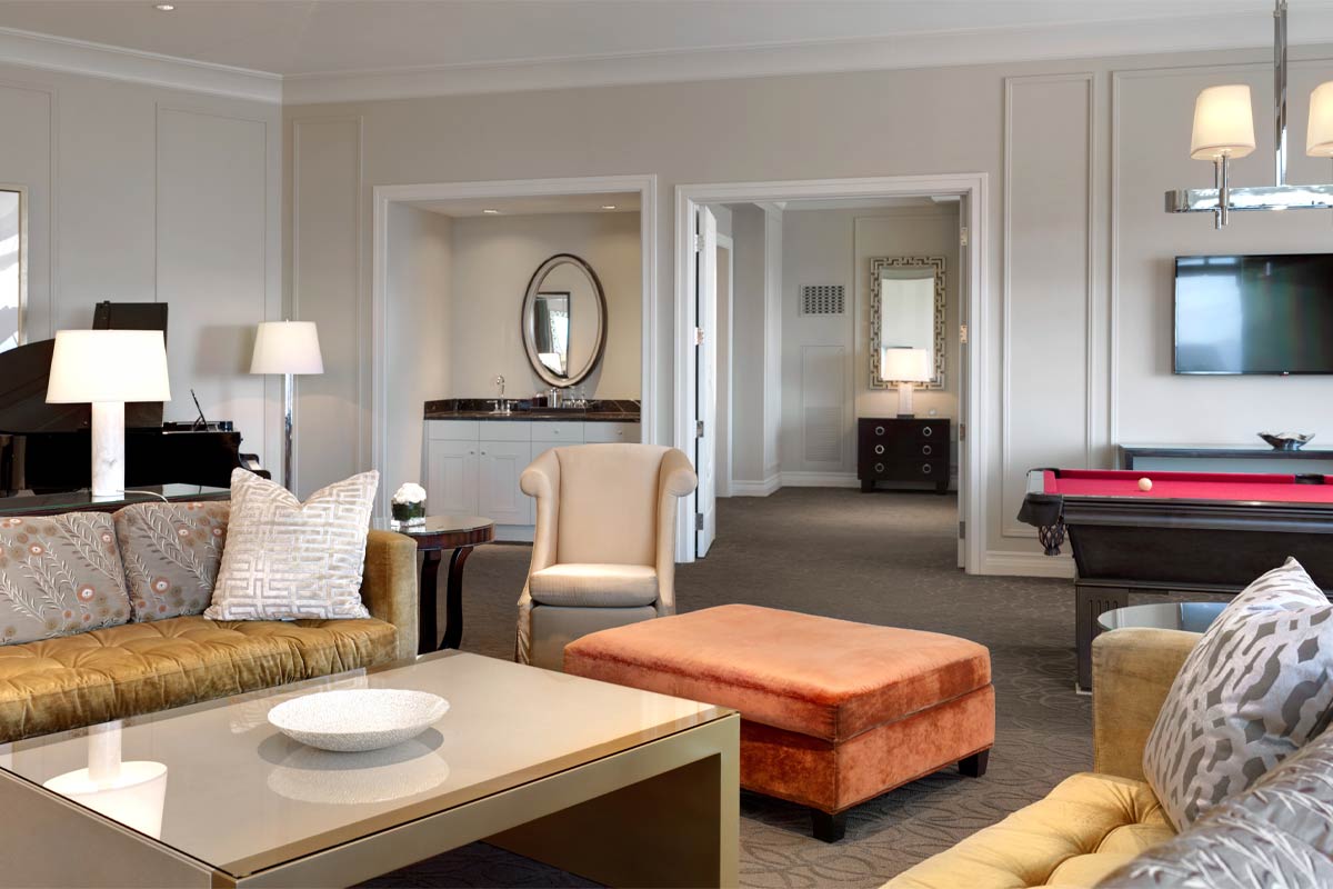 Luxurious living room with sofas, a billiards table, a grand piano, modern decor, and ambient lighting.