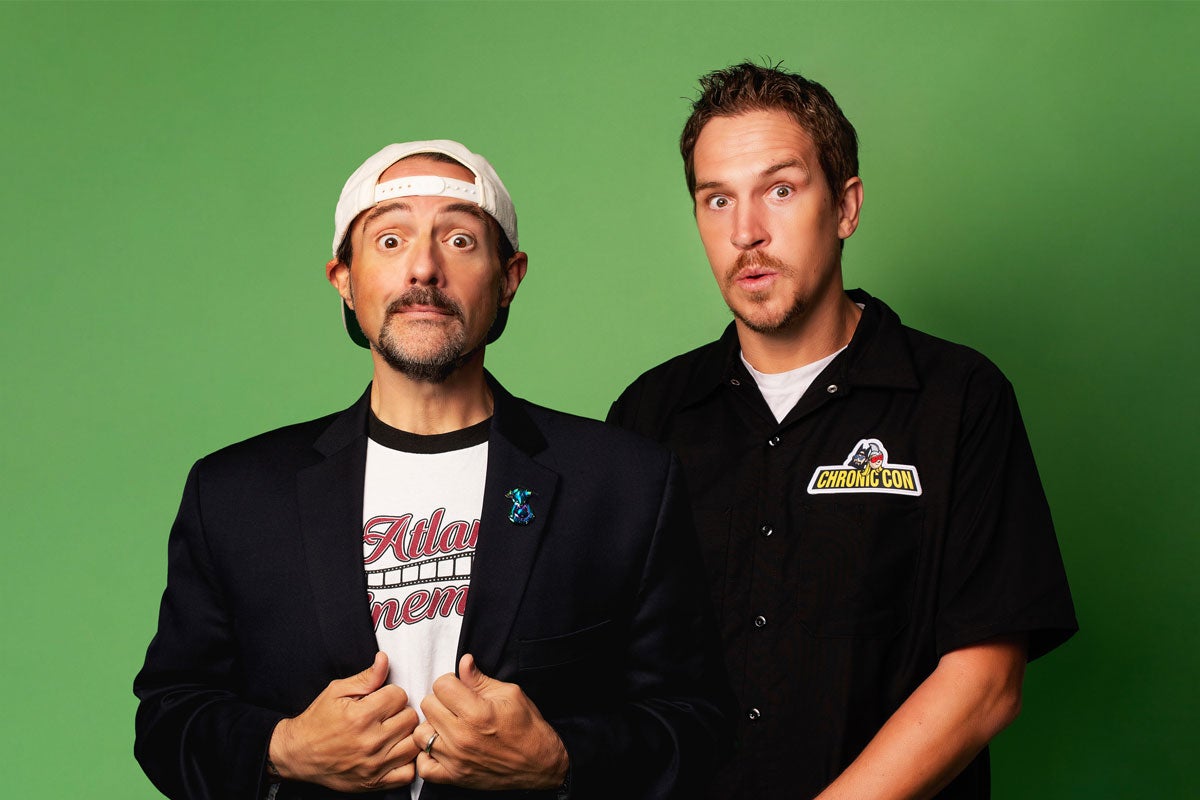 Jay & Silent Bob posing with surprised expressions in front of a green background.