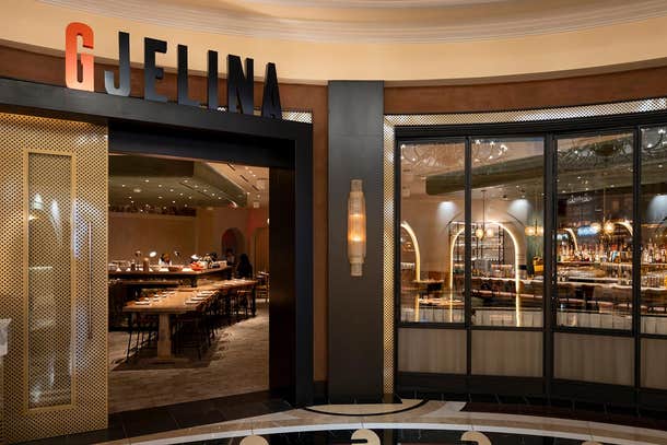 Gjelina entrance with perforated golden doors and visible interior seating.