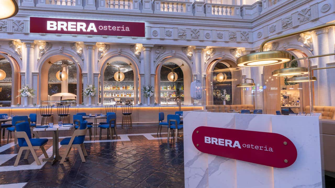 Open restaurant setting with a red “BRERA” sign