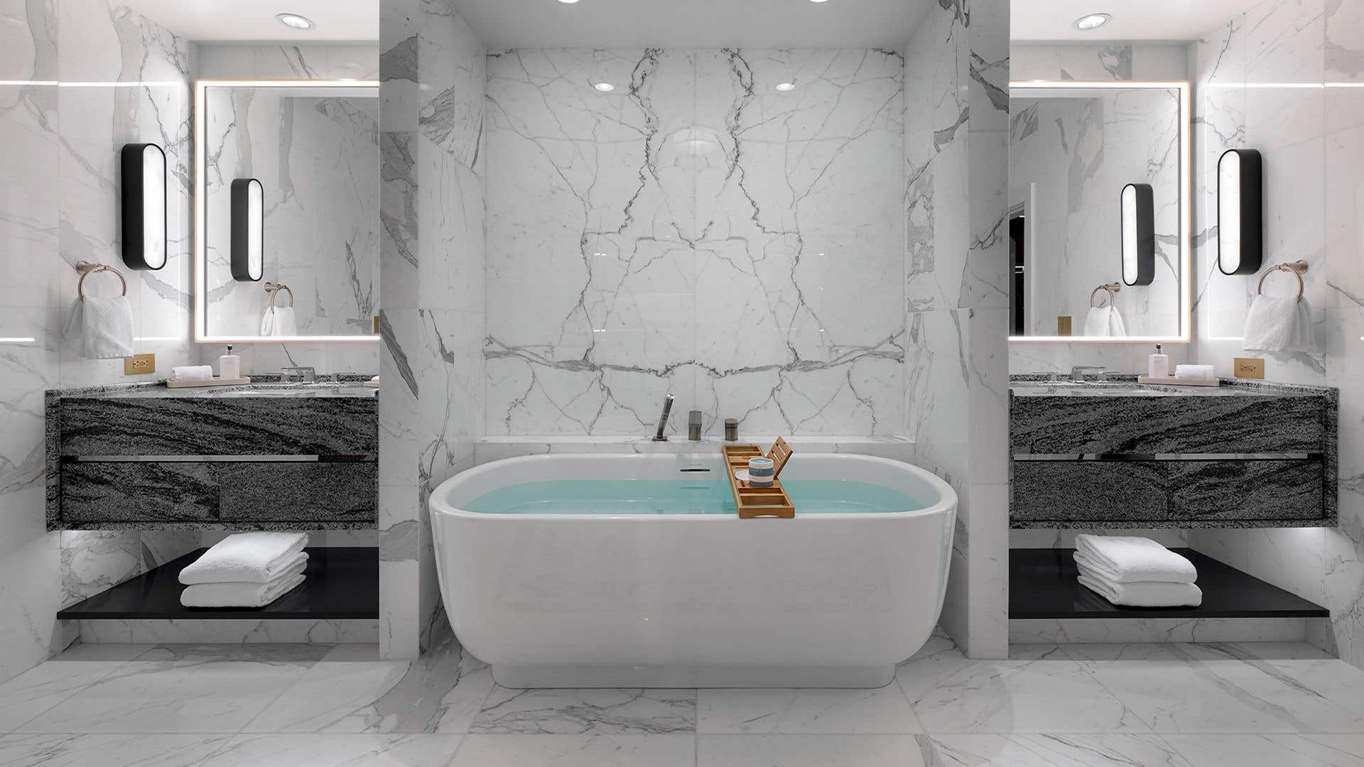A large, white marble bathroom with freestanding tub and a sink on either side.