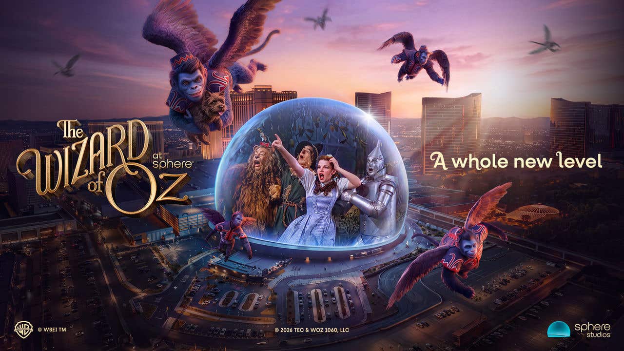 The Wizard of Oz at Sphere poster showing the main characters in a bubble over a city with flying monkeys.