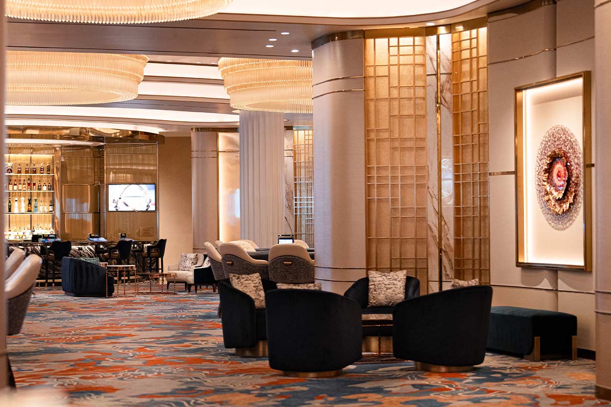 A luxurious lounge with a seating area, bar, and artwork.