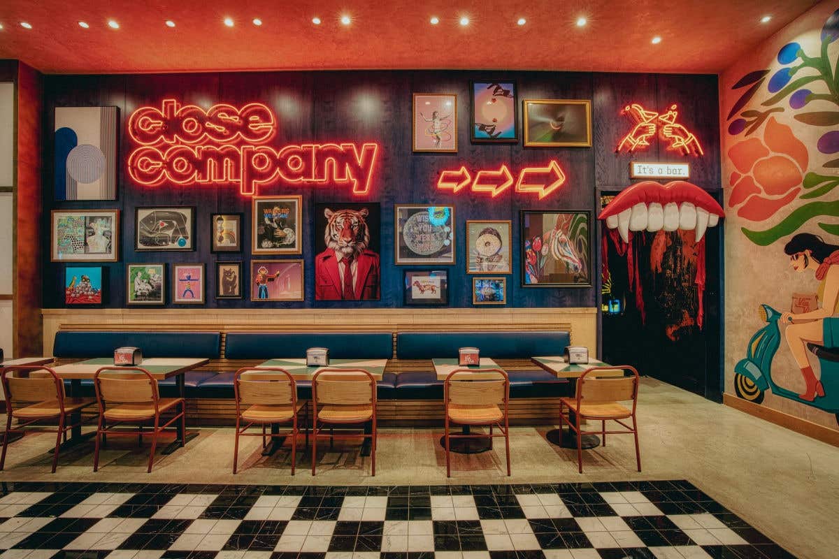 Close & Company bar exterior with neon signage and framed artwork.