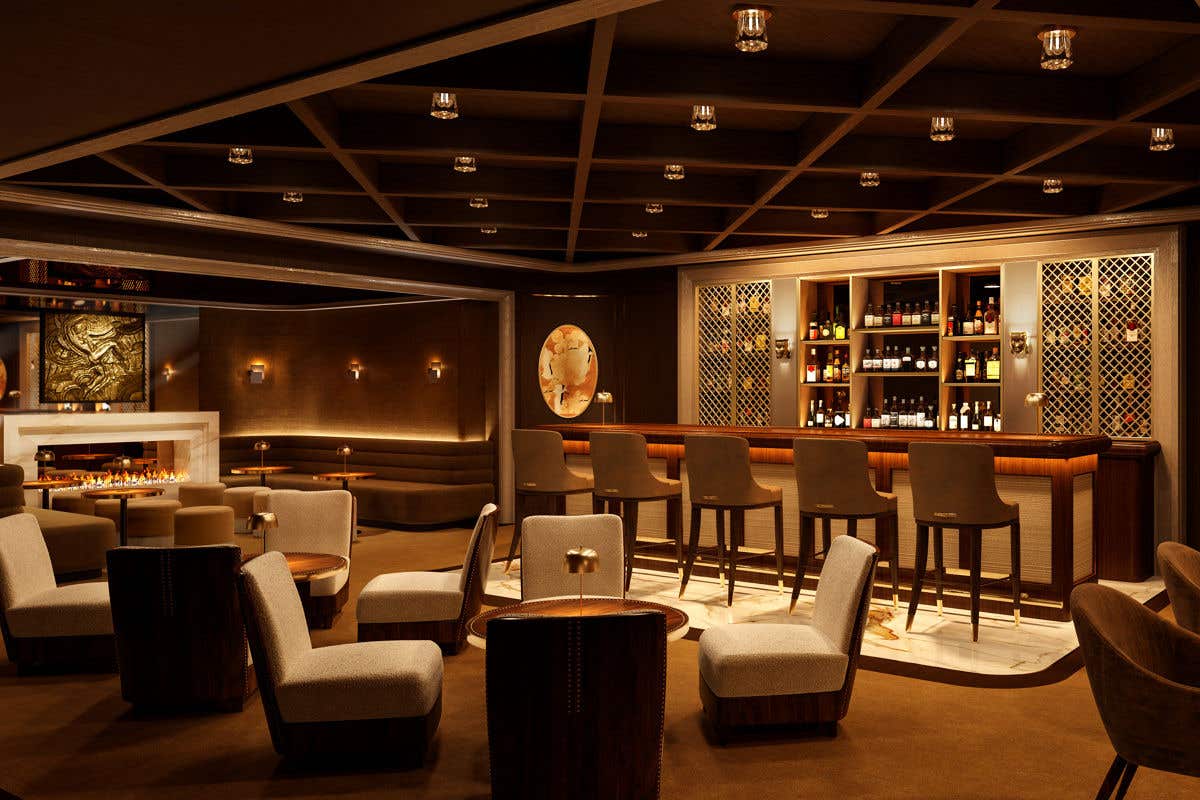 A warmly lit lounge with modern chairs, low tables, and a central bar stocked with spirits. Soft lighting, wood accents, and a sleek fireplace create an intimate, upscale atmosphere.