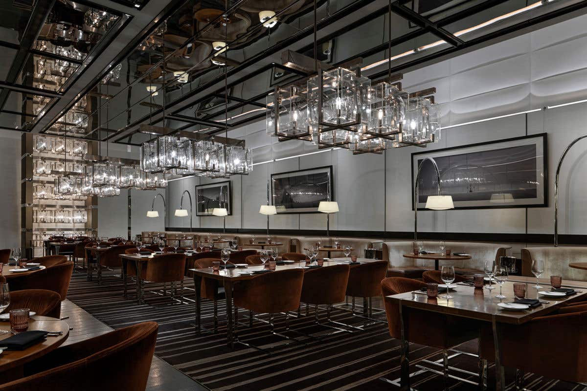 Modern upscale dining room with glass pendant lighting and sleek décor.