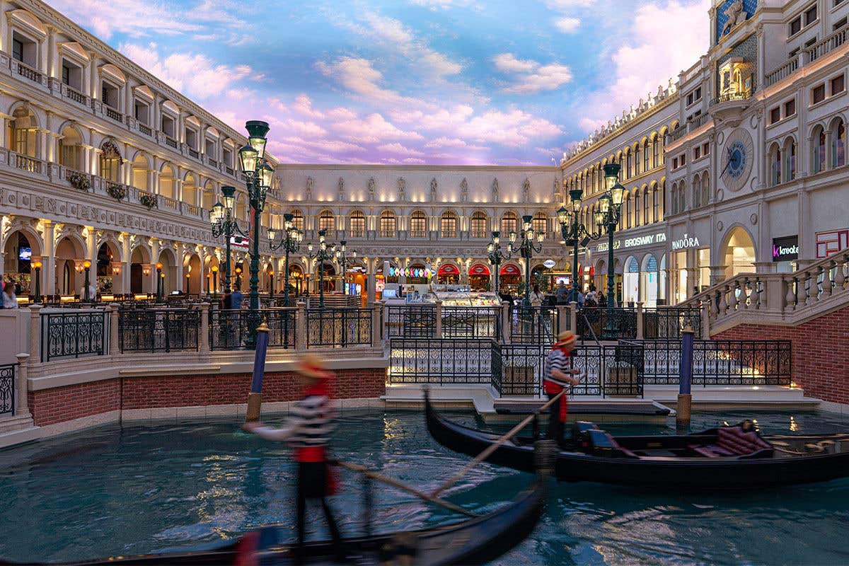 St. Marks Square inside The Grand Canal Shoppes at The Venetian Resort Las Vegas featuring two gondolas steered by gondoliers in the foreground of the image