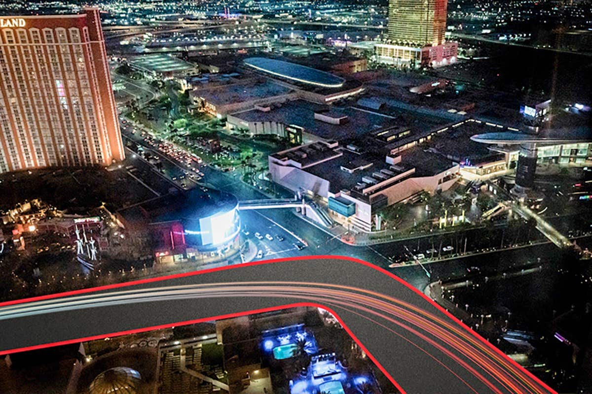 Night aerial view of a vibrant cityscape with illuminated buildings and streets, featuring light trails from vehicles.
