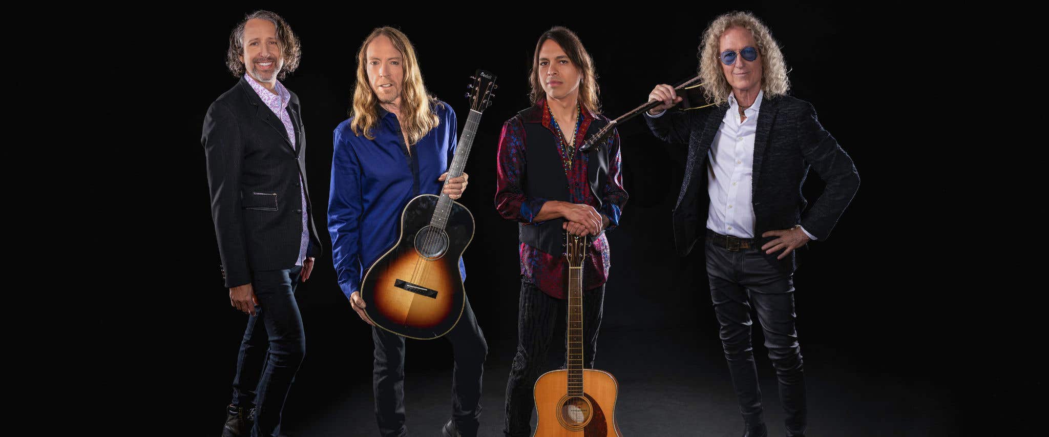 FOREIGNER the band standing in front of dark background holding their instruments. 