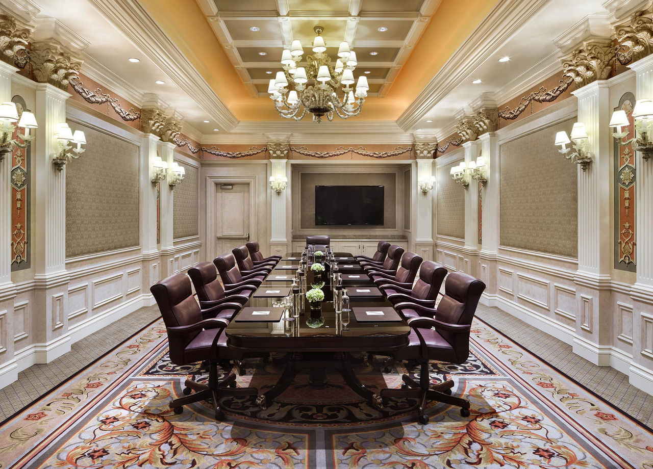 Interior of the Toscana Boardroom at Venetian set up for a meeting with a long boardroom table, chairs & table decor