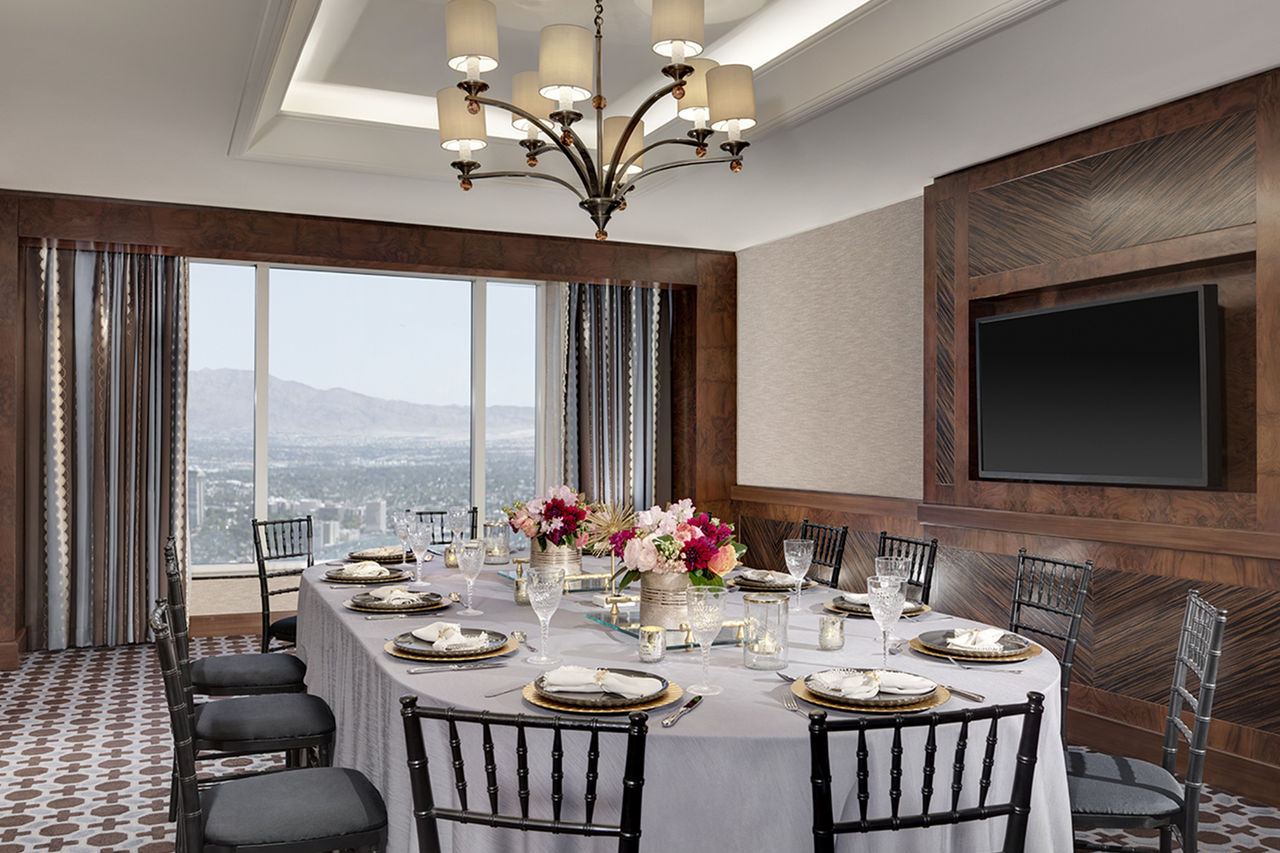 A room plated for 12 people with a view of the mountains. 